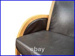 2 Rattan and black leather armchairs Lloyd Loom armchair