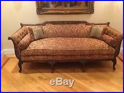 Antique French sofa in walnut wood with beautiful carving details. Tufted sides