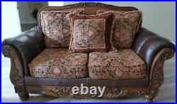 Pick up only FABRIC AND FAUX LEATHER LOVESEAT WITH ORNATE CARVED WOOD. Exc cond