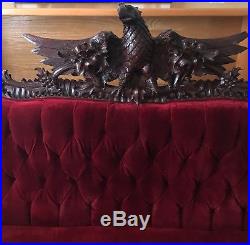 The American eagle is proudly featured in an elaborately carved sofa