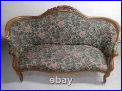 Victorian Era Upostered Parlor Sofa Hand Carvings With Vintage Porcelain Casters