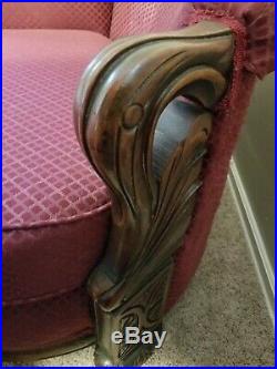 Vintage antique upholstered sofa with beautiful carved details